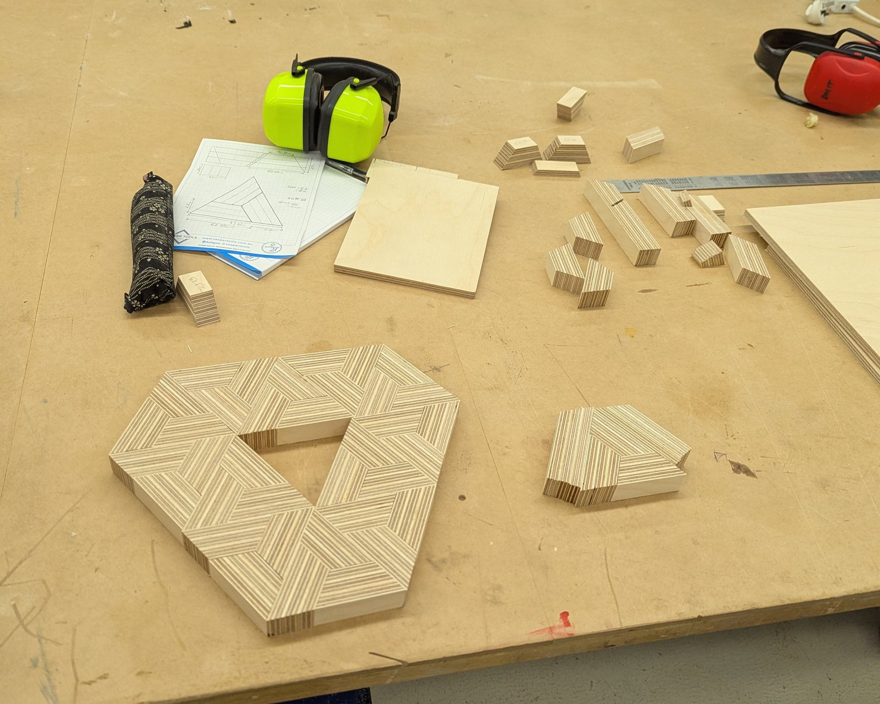 The hexagonal end-grain pattern dry-fitted on the bench beside a glue bottle