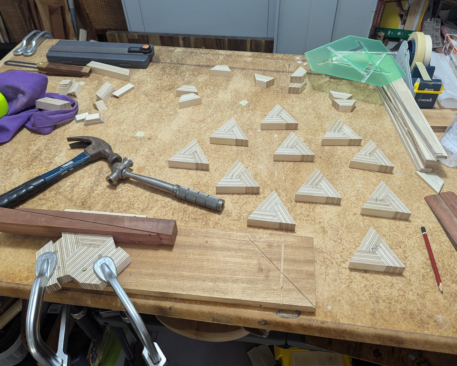 Machined plywood segments and tools on the workbench