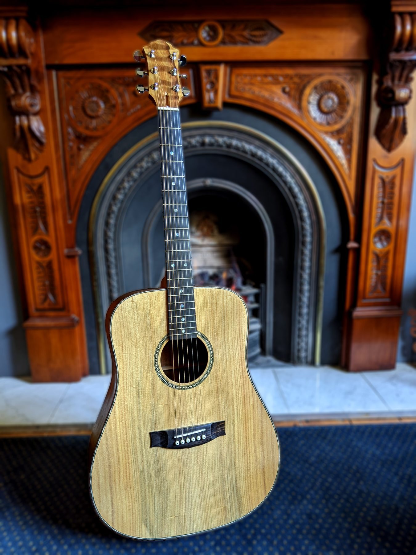 The completed dreadnought standing in front of a Victorian fireplace