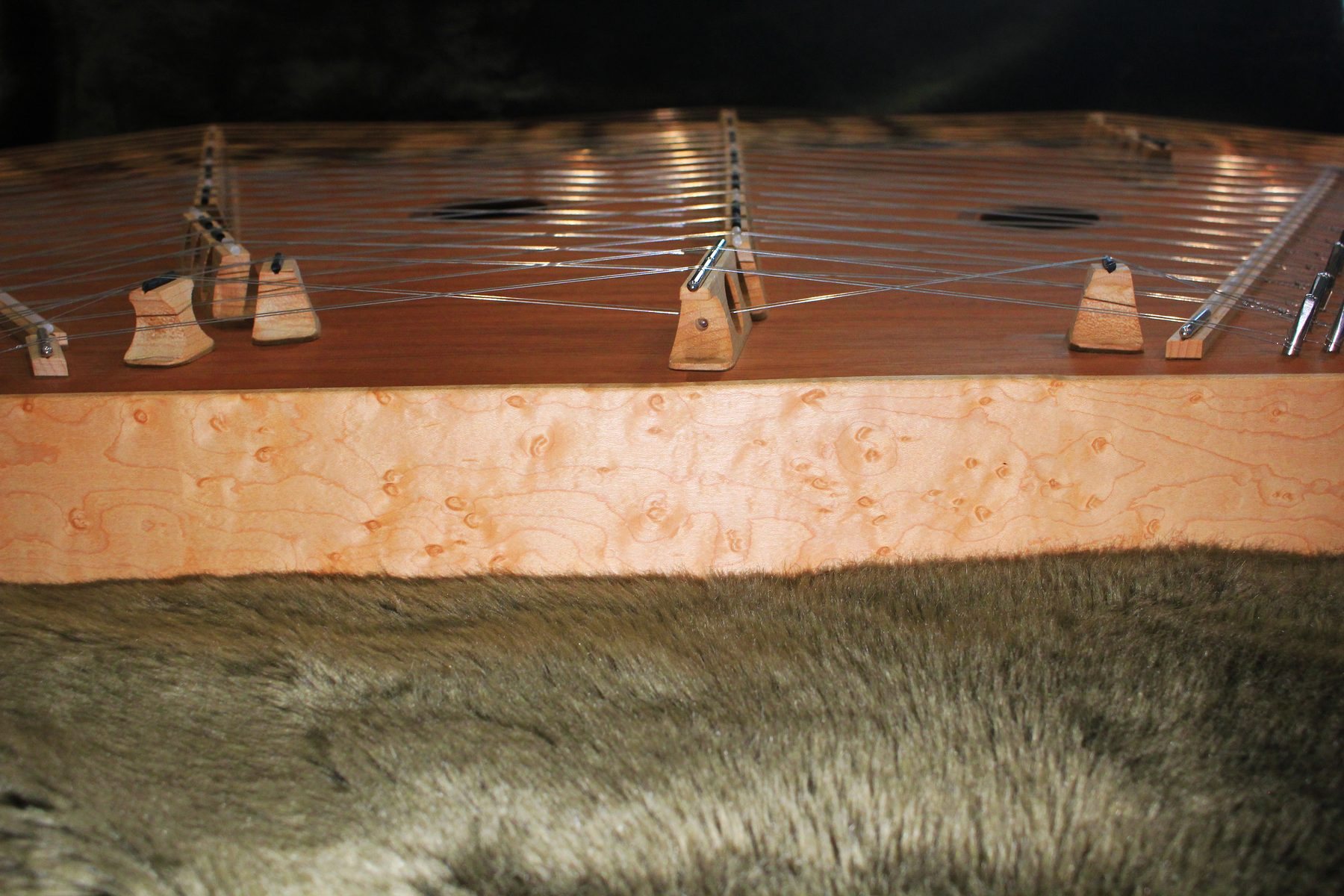 The birdseye maple rail and bridges of the dulcimer