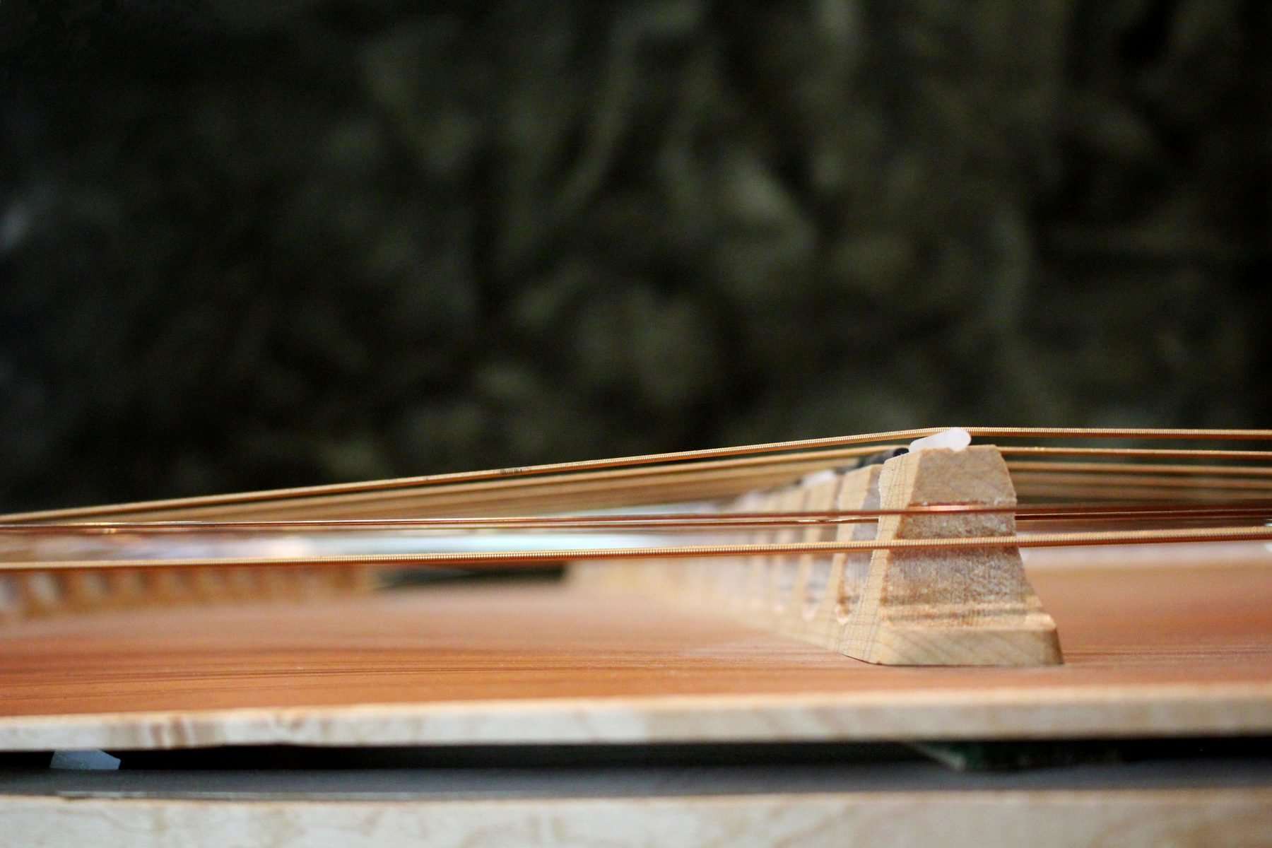 A low view along the string courses of the dulcimer