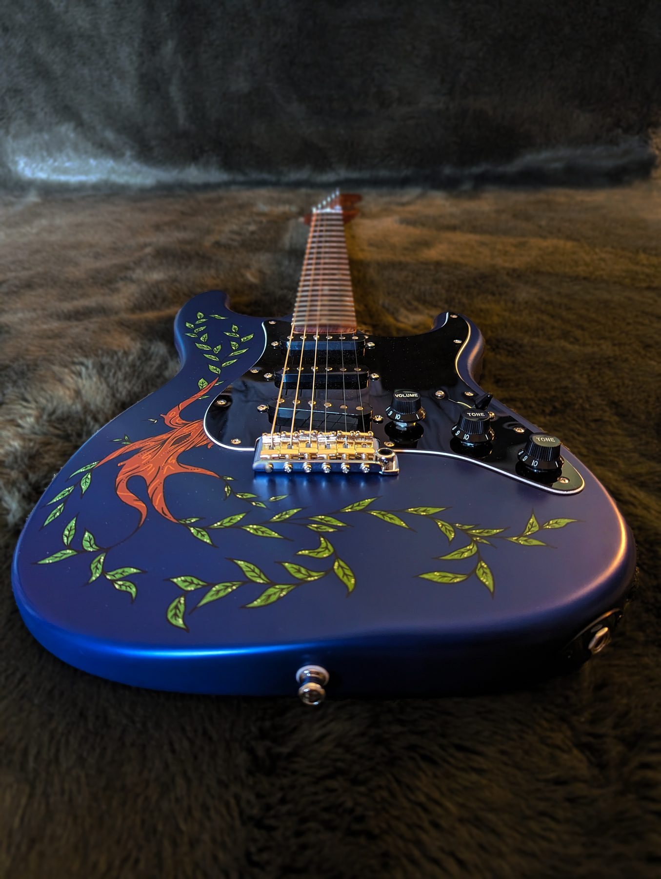 Angled view of the Willowcaster body and painted willow artwork
